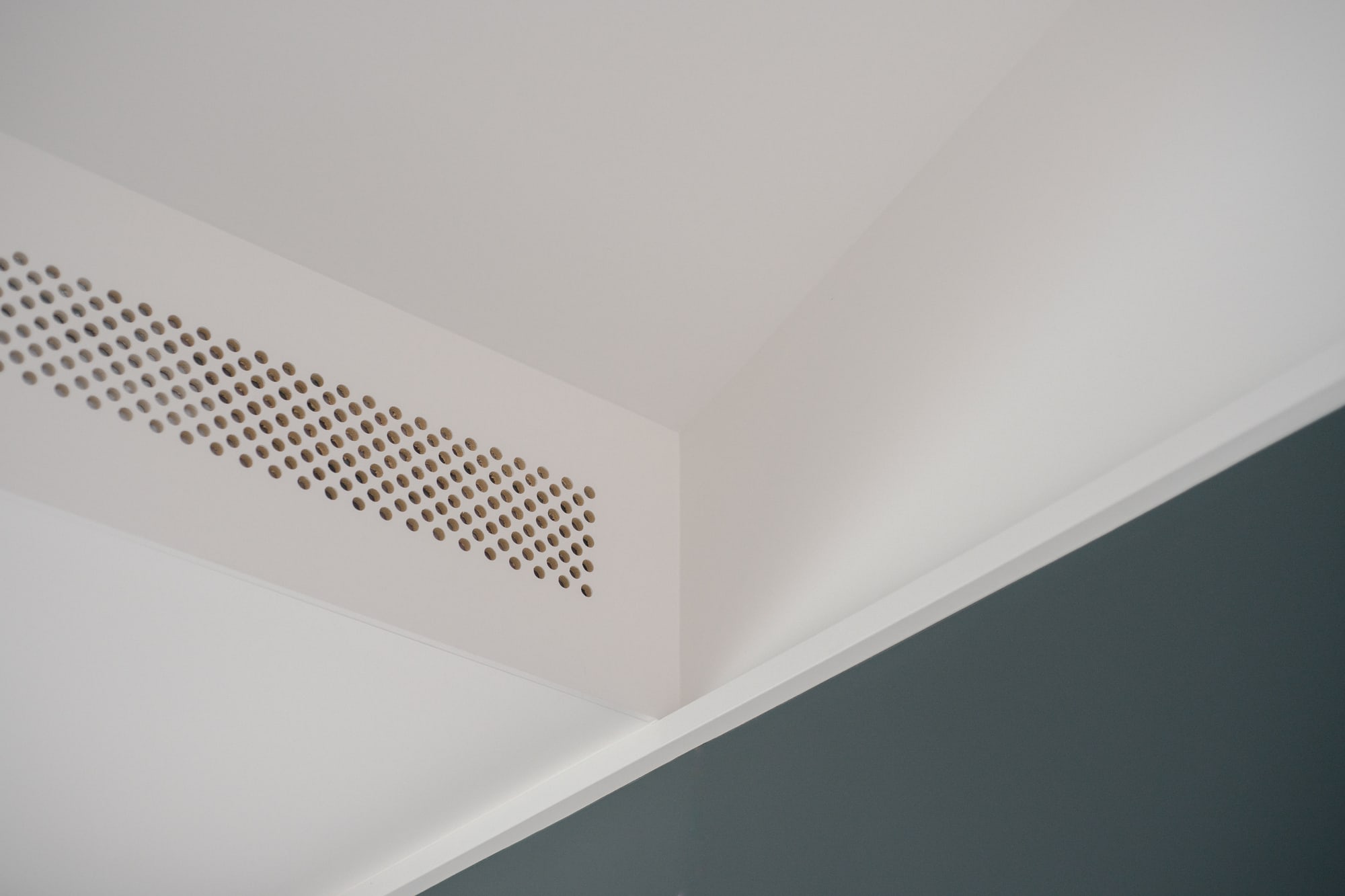 Photography: Shane Hauser Baycrest — Perforated ventilation detail above dark-framed glazing