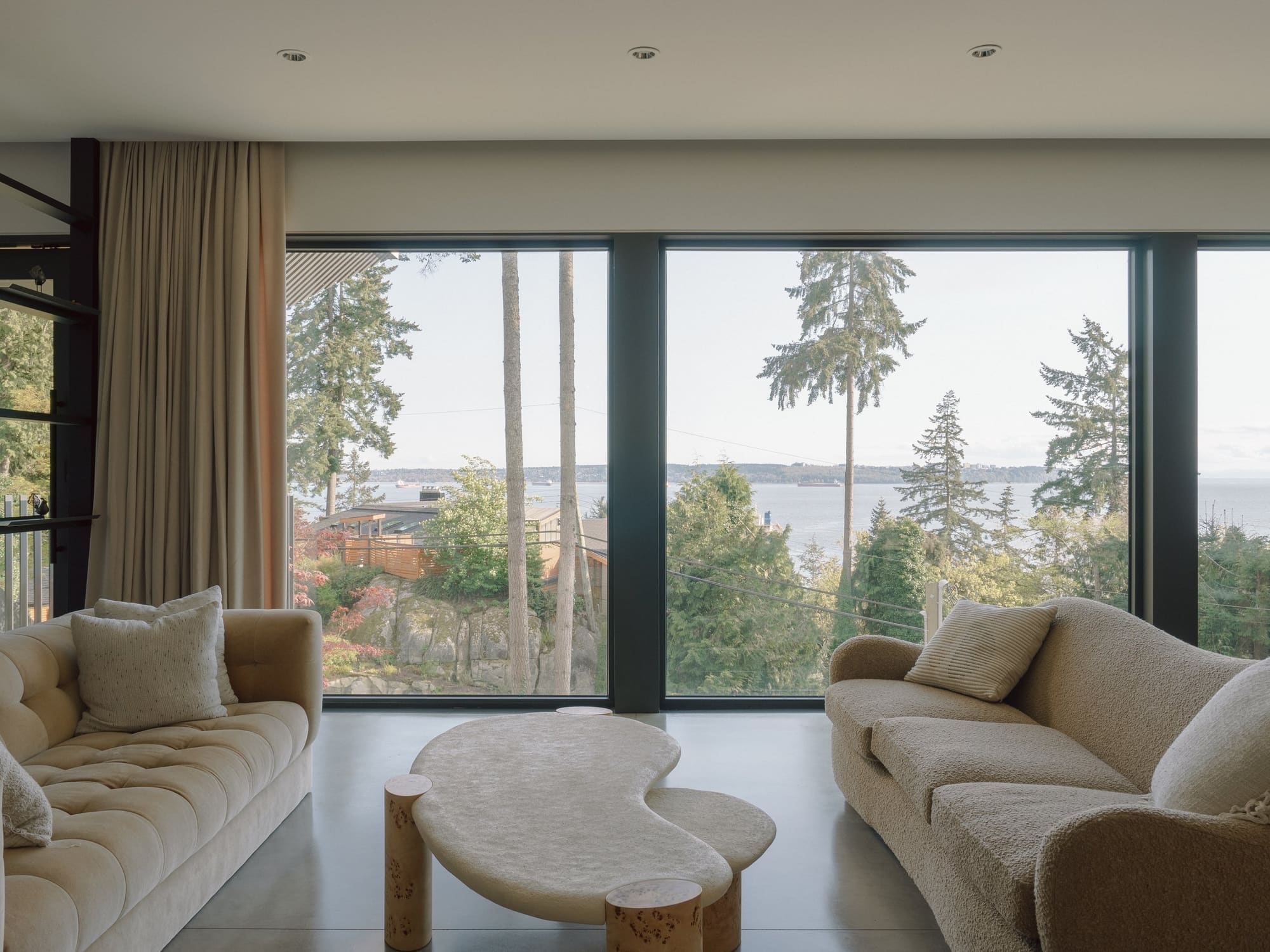 Bayridge — Seating area beside full-height garden glazing
