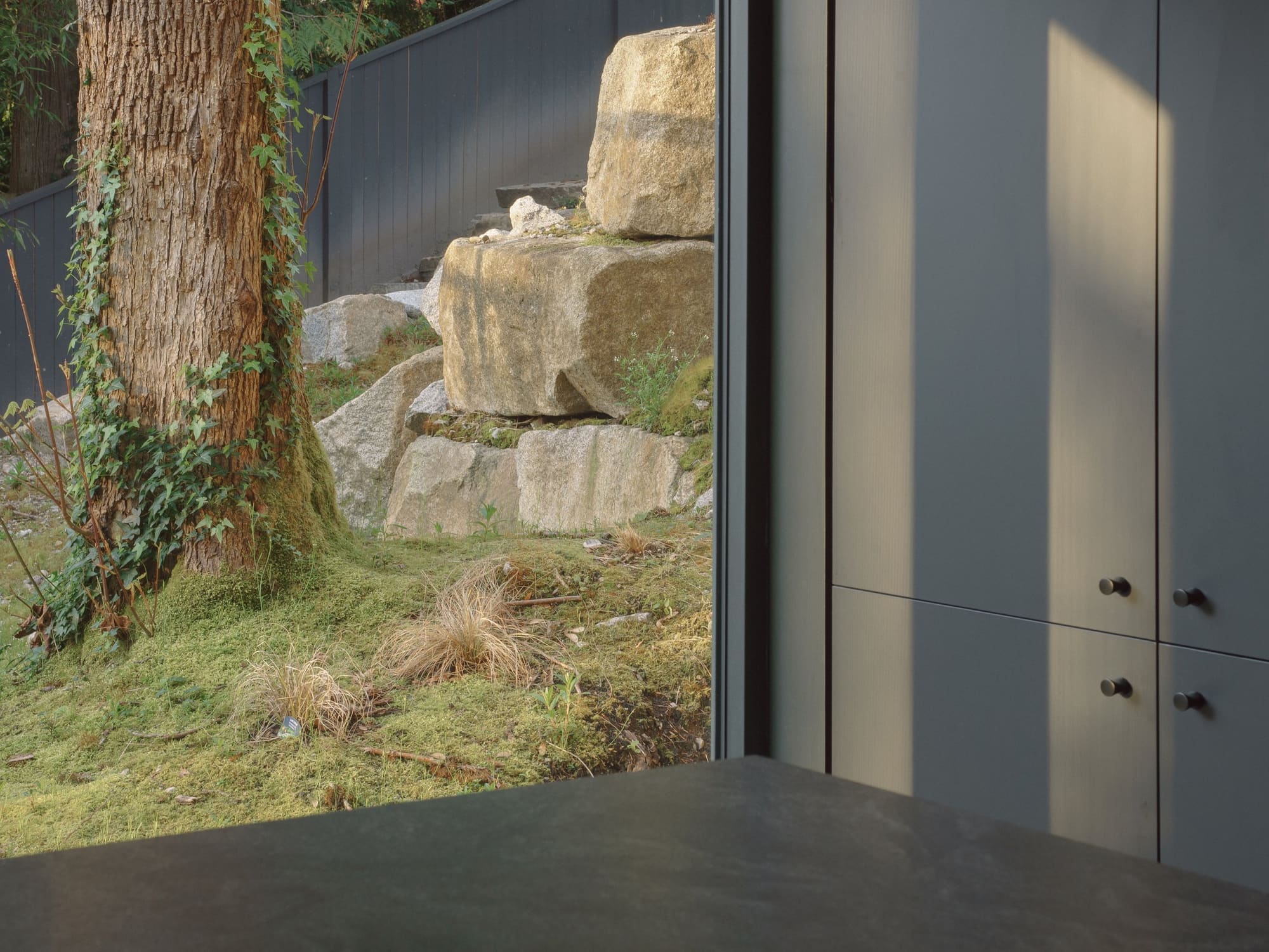 Bayridge — Entry door beside exposed natural rock