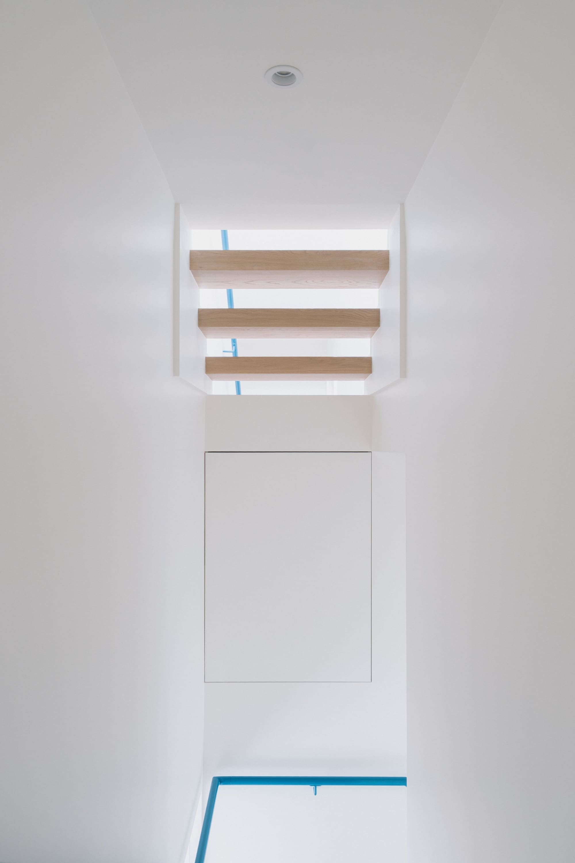 Photography: Shane Hauser Gladstone — Daylight entering above the interior stair
