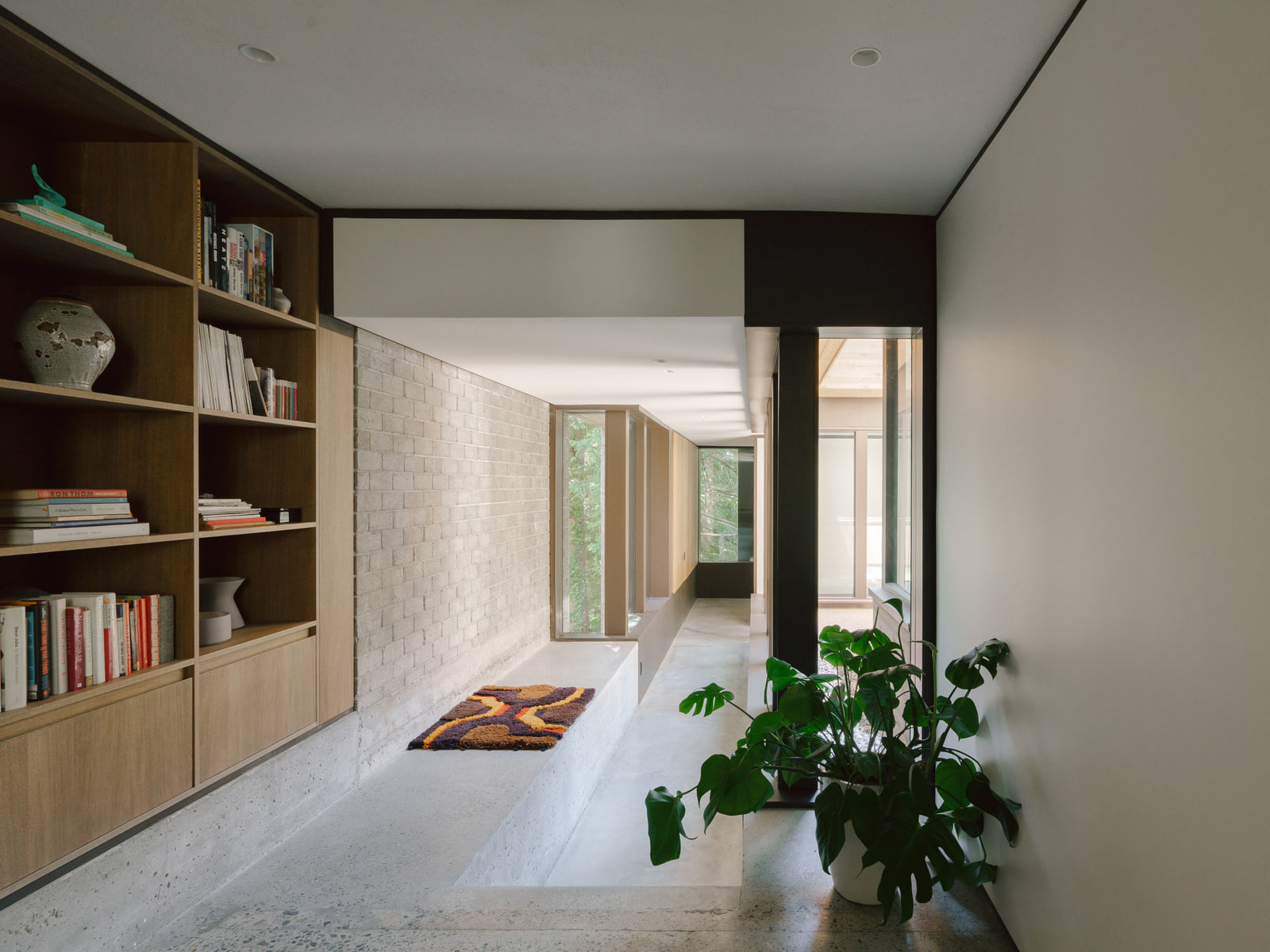 Built-in shelving and a long interior view through Fells House.