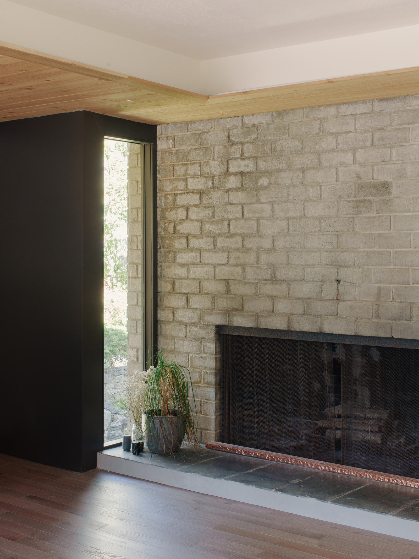Original masonry fireplace and corner glazing at Fells House.