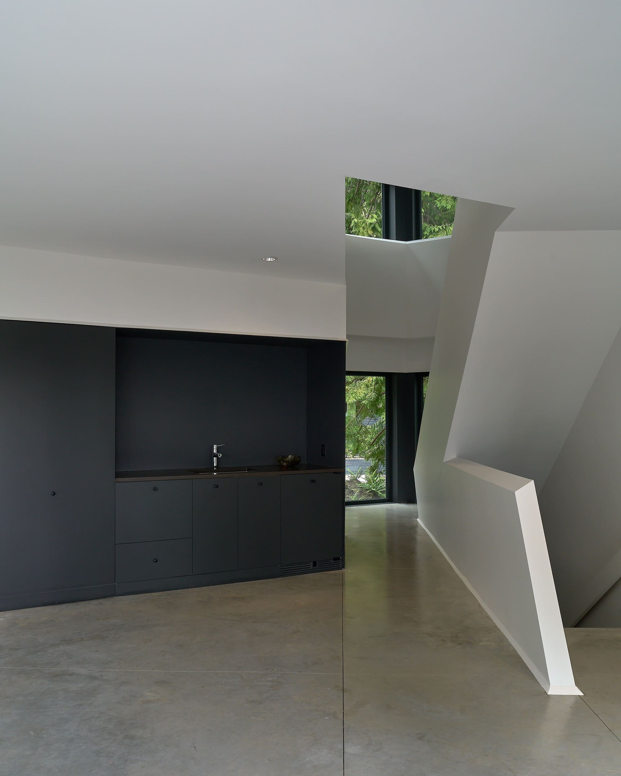 Photography: Sama Jim Canzian House With Big Shingles — Angular white stair beside dark built-in cabinetry