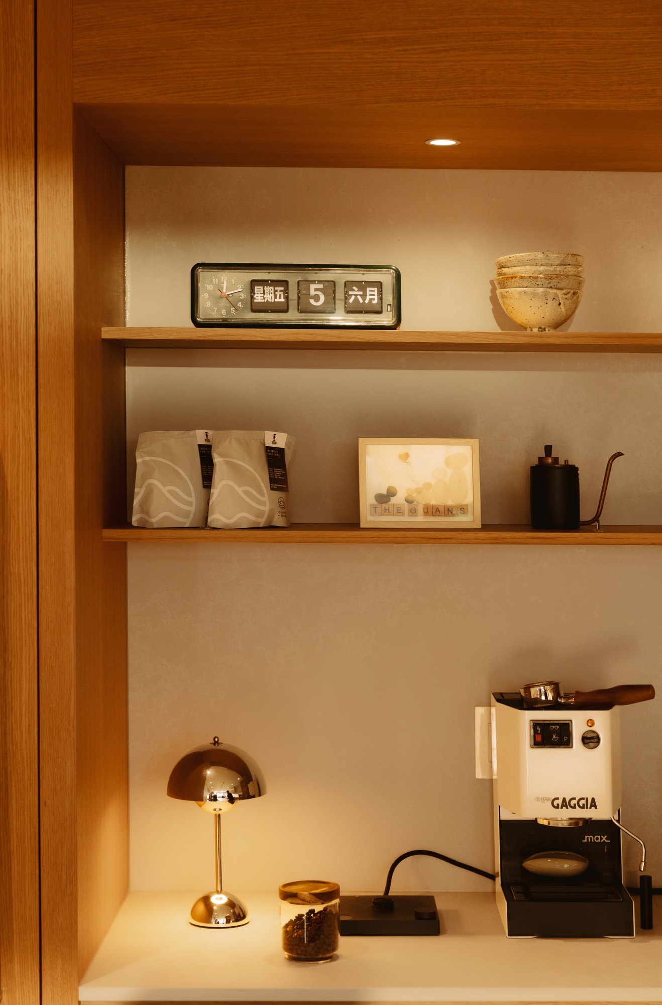 Built-in coffee station with open timber shelving.