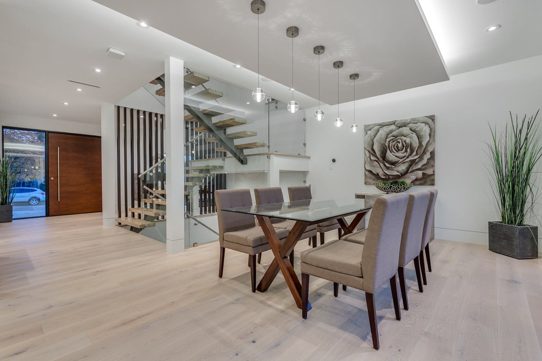 Wavertree — Dining table below pendant lights beside an open stair