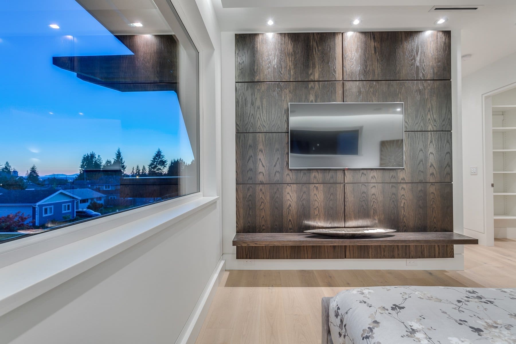 Wavertree — Timber-clad media wall beside a dusk view