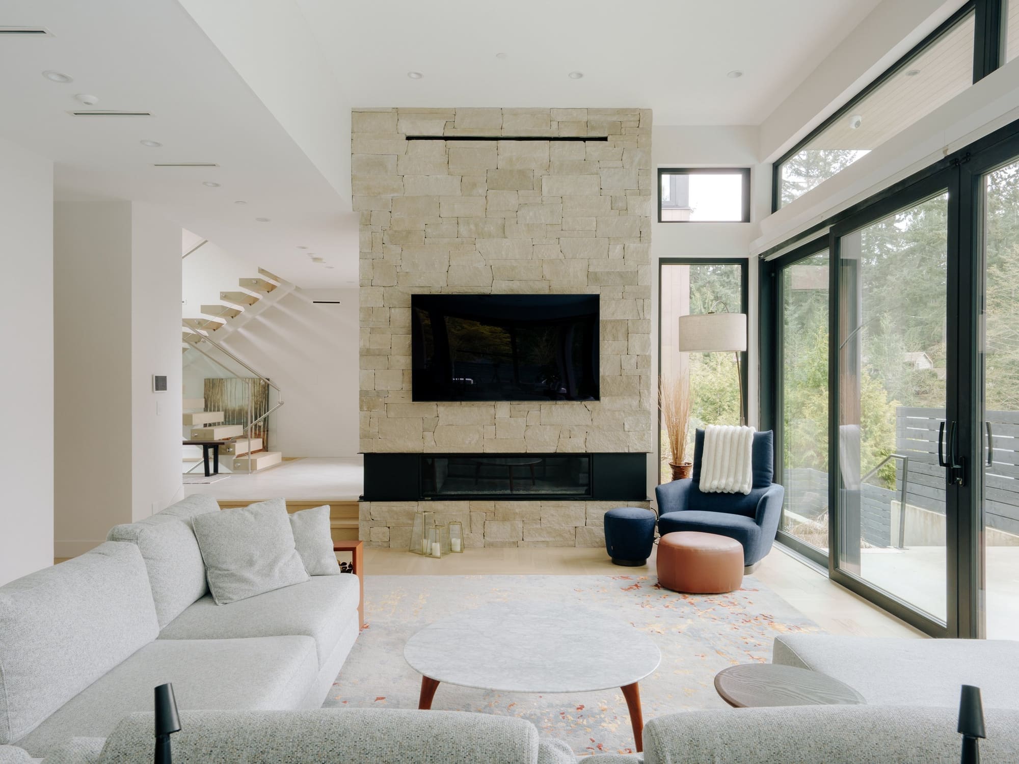 Photography: Shane Hauser Woodgreen — Living room with a stone fireplace and garden glazing